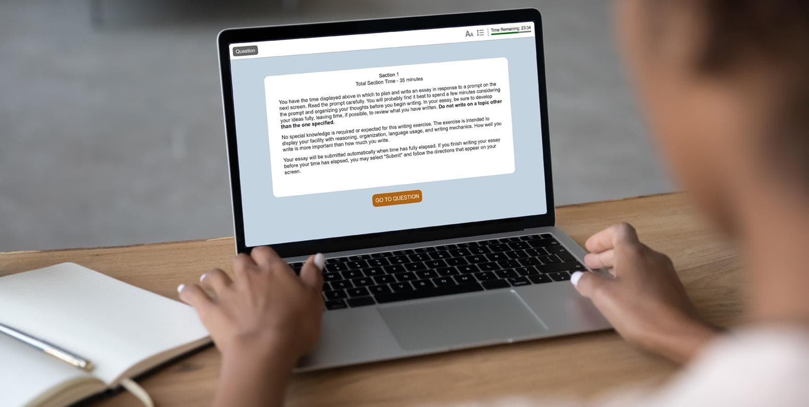 A woman focused on her laptop, typing.